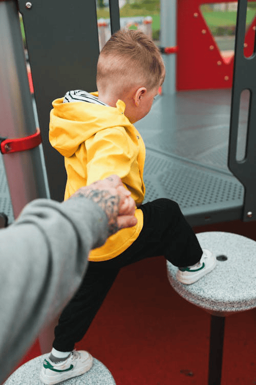 Father playing with a young son at a park, representing shared parenting time