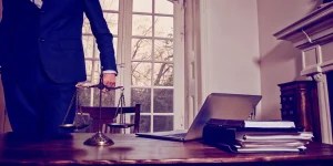 Spousal support attorney in White Marsh, MD balancing the scales of justice in a law office.